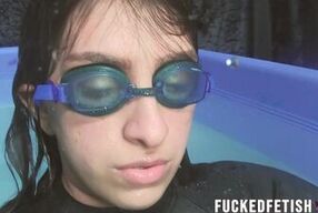 Watch Mia Closeup's submissive girl in black skinny neoprene swimsuit get drenched in the pool