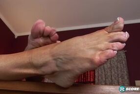 Watch this hot brunette indulge in her foot fetish in stunning solo video