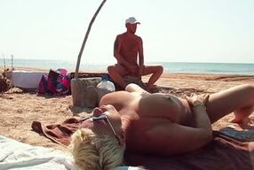 Naughty blonde gets her big tits and ass toyed by stranger while getting pounded on public beach