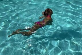 Monika Fox Poses In Pink Bikini And Swims In Pool Surrounded By Skyscrapers