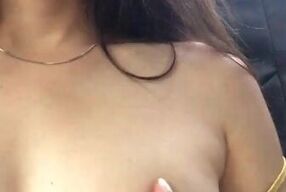 beautiful girl in her dress films her big, rich tits and fingers her pussy in the back seat of the u