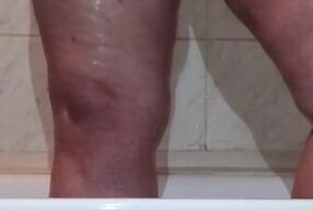 I caught a chubby mom playing with her fat pussy in the shower
